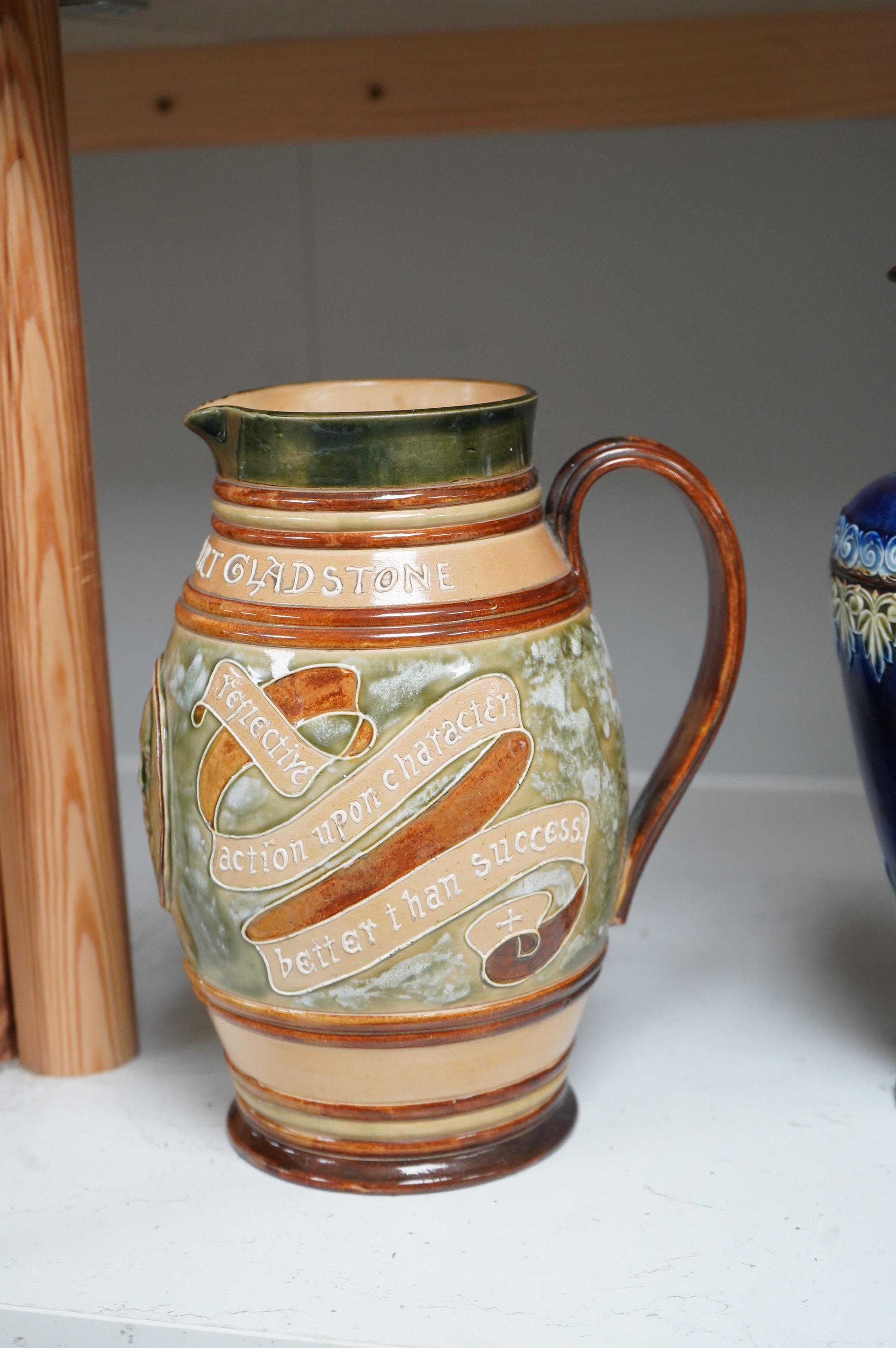 A Doulton Lambeth stoneware commemorative pitcher of William Ewart Gladstone 23cm high, together with a pair of vases two handled vase and a mug, (5).